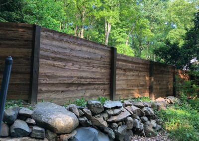 reclaimed mushroom boards used for privacy fence in a yard
