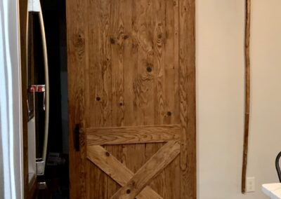 reclaimed mushroom boards used for a custom sliding barn door in a home
