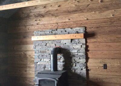 reclaimed mushroom boards used for wall paneling in a home behind fireplace