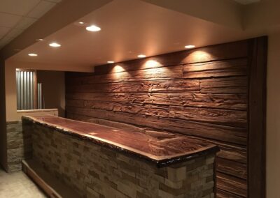 reclaimed mushroom boards used for wall paneling in a home finished basement bar