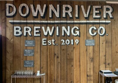 reclaimed mushroom boards used for wall paneling and custom sign work for Downriver Brewing Co.