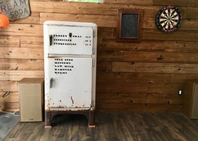 reclaimed mushroom boards used for wall paneling in a home next to old refrigerator