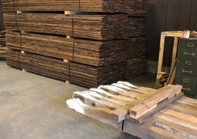 stack of reclaimed mushroom boards in warehouse